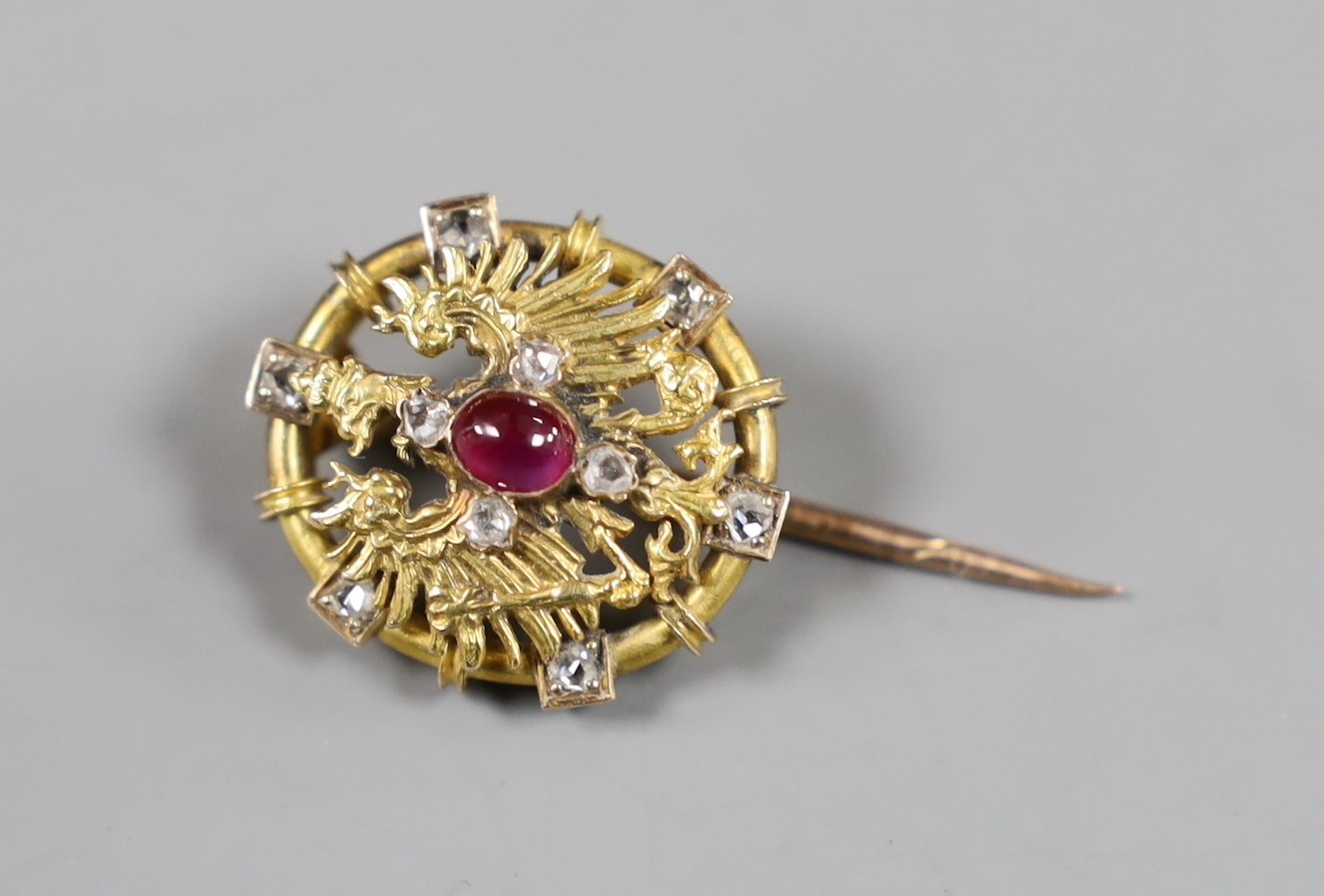 An early 20th century yellow metal, red cabochon and rose cut diamond cluster set short stick pin, with oval terminal, 31mm, gross weight 5.4 grams.